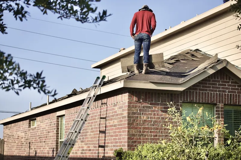 Professional roofer working on a residential roof in Fontana Village